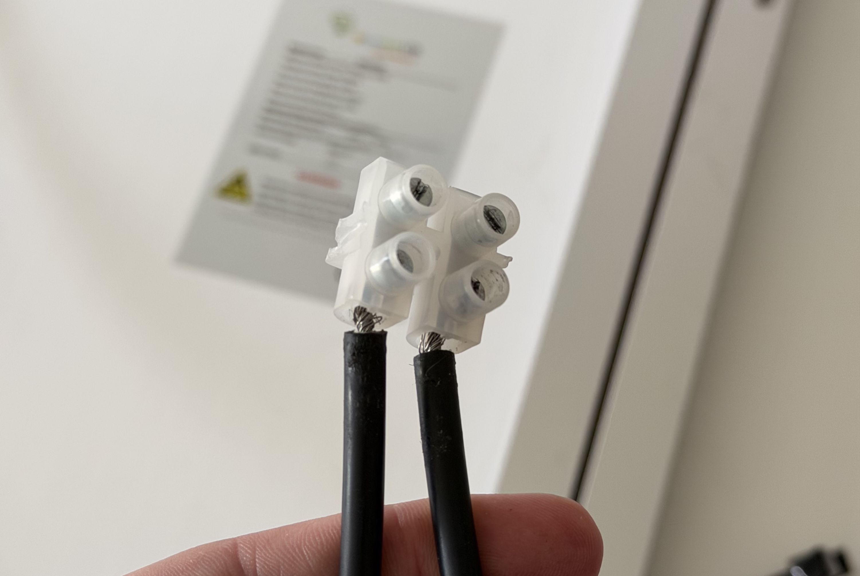 Photo showing the solar panel wires connected to the screw terminal block. Photo showing the solar panel wires connected to the screw terminal block.